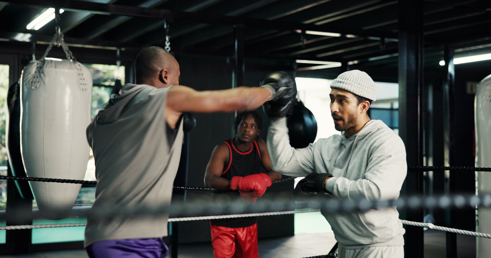 Boxer punching in boxing ring during fitness training